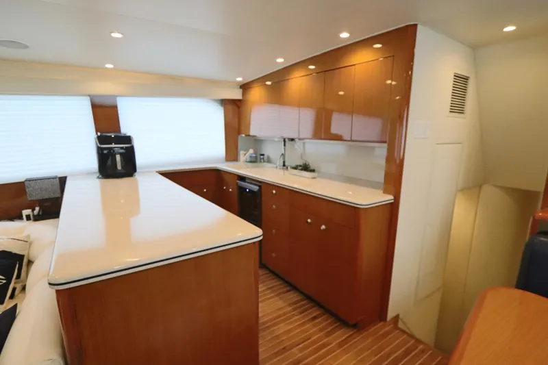 Angie Yacht Photos Pics Luxurious kitchen interior of a 2000 Viking 65 yacht with modern amenities.