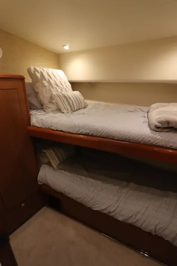 Angie Yacht Photos Pics Bunk beds in a 2000 Viking 65 yacht cabin with cozy lighting.