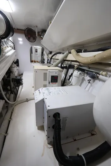 Angie Yacht Photos Pics Engine room of a 2000 Viking 65 yacht, featuring machinery and piping.