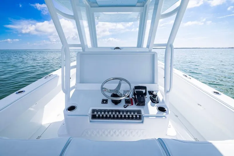  Yacht Photos Pics 2026 Invincible 33 Catamaran helm with ocean view, showcasing modern controls and steering.