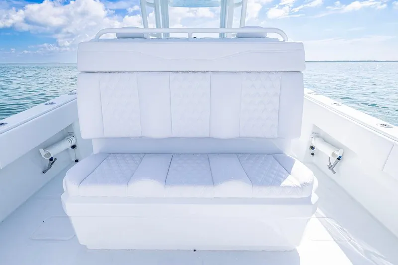  Yacht Photos Pics Luxurious seating on 2026 Invincible 33 Catamaran, featuring white upholstery and ocean backdrop.