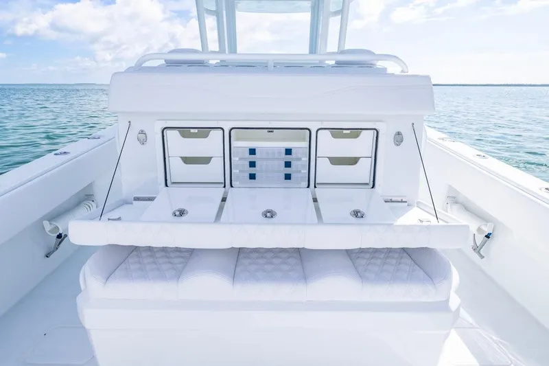  Yacht Photos Pics 2026 Invincible 33 Catamaran interior with storage compartments and seating, on calm ocean waters.