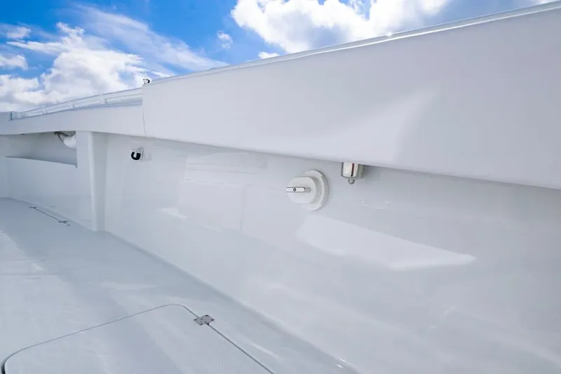  Yacht Photos Pics 2026 Invincible 33 Catamaran deck with sleek white finish under blue sky.