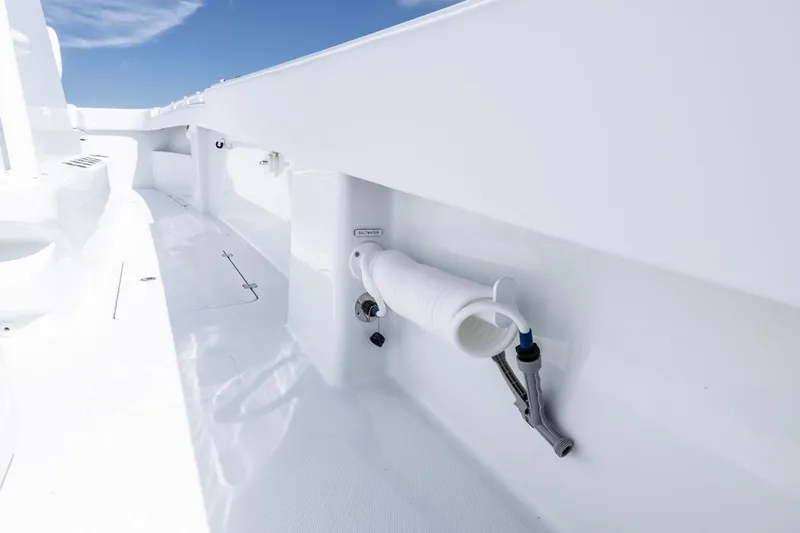  Yacht Photos Pics 2026 Invincible 33 Catamaran deck with coiled hose and sleek white finish.