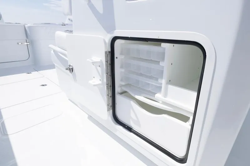  Yacht Photos Pics Open storage compartment on 2026 Invincible 33 Catamaran, showcasing interior shelving.