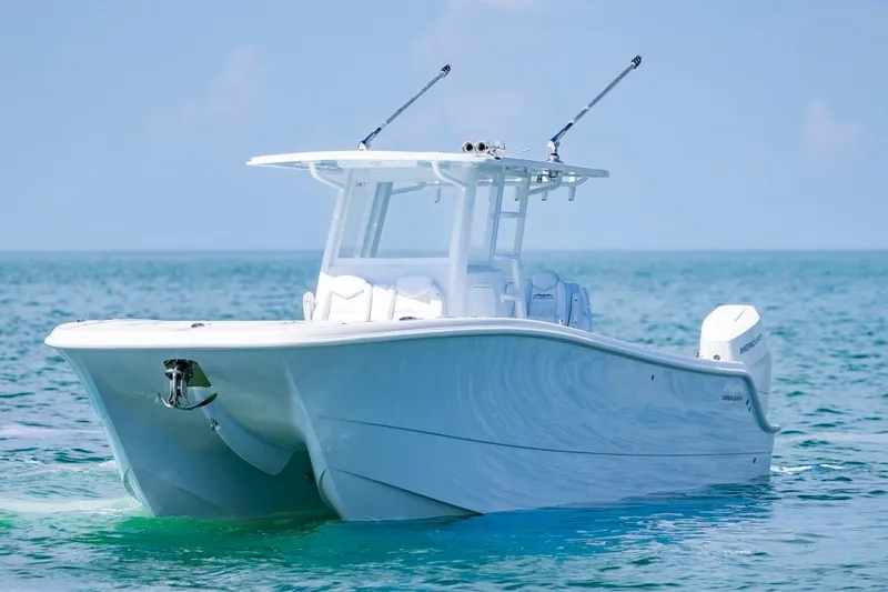  Yacht Photos Pics 2026 Invincible 33 Catamaran on calm ocean waters, showcasing sleek design and modern features.