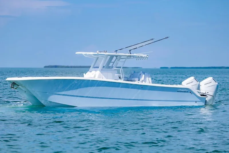  Yacht Photos Pics 2026 Invincible 33 Catamaran on calm blue ocean waters.