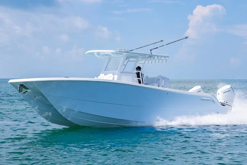  Yacht Photos Pics 2026 Invincible 33 Catamaran cruising on open water under clear skies.