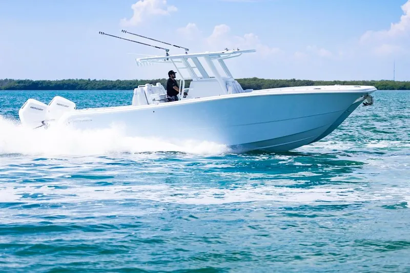  Yacht Photos Pics 2026 Invincible 33 Catamaran cruising on open water, showcasing sleek design and powerful engines.