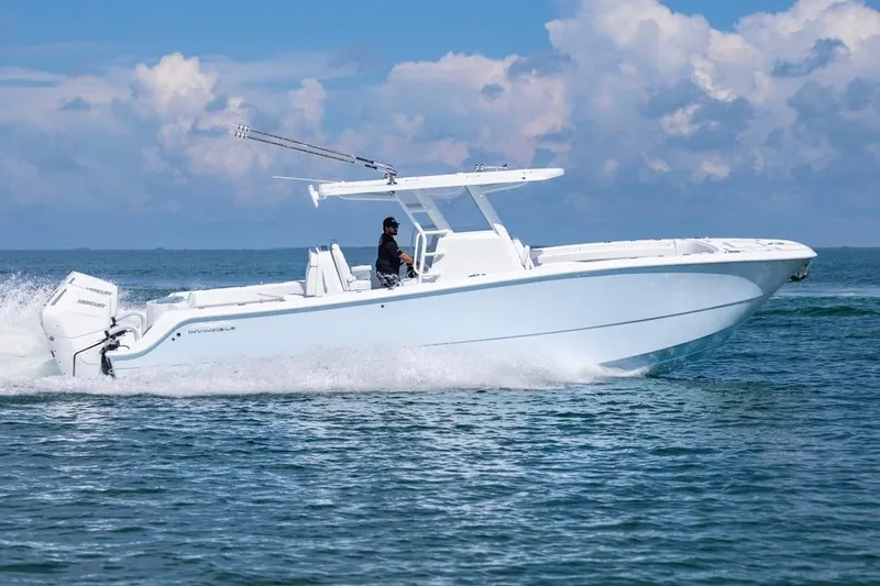  Yacht Photos Pics 2026 Invincible 33 Catamaran cruising on open water under a clear sky.