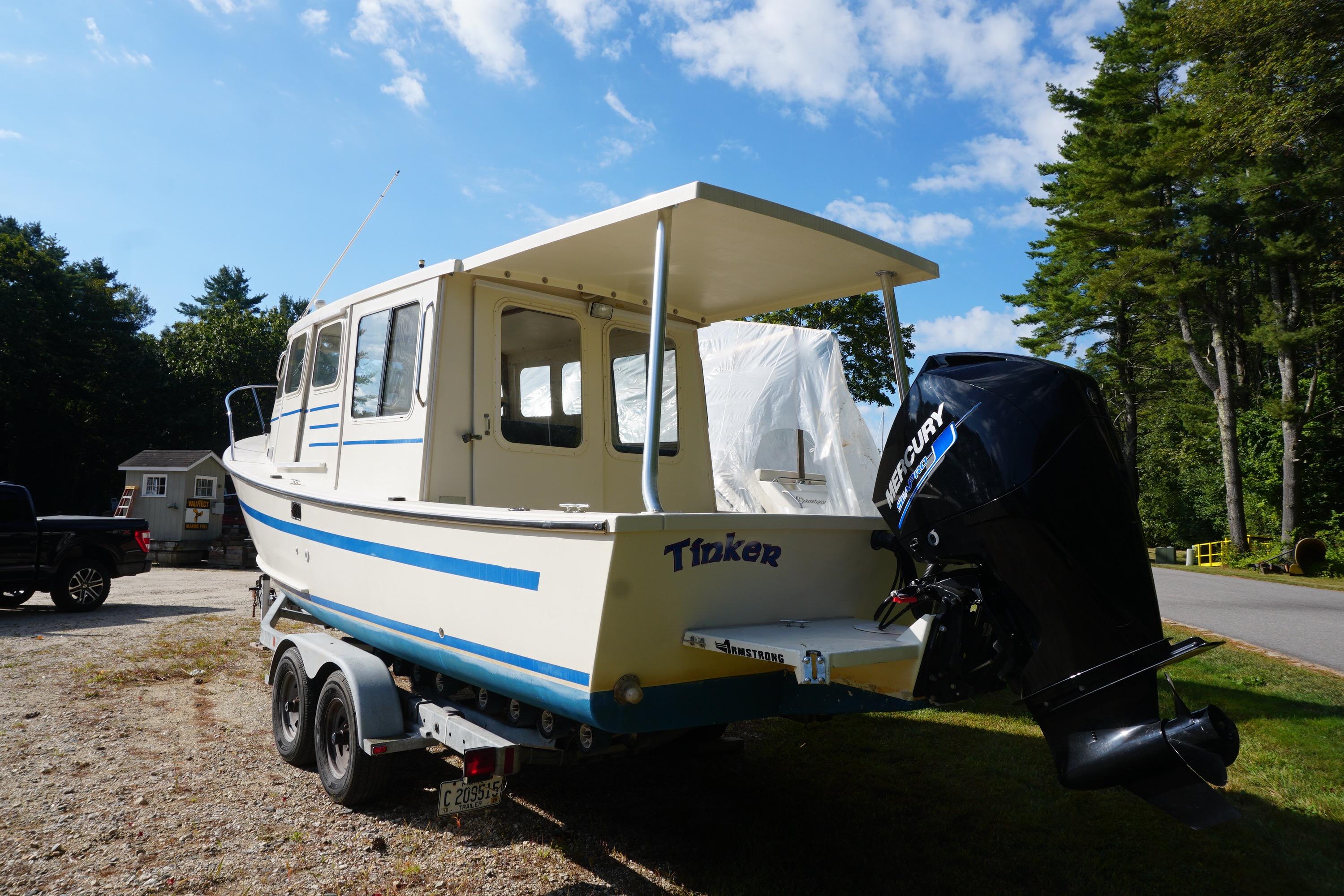 2002 Rosborough RF-246 Sedan Cruiser on trailer, parked outdoors under a blue sky.