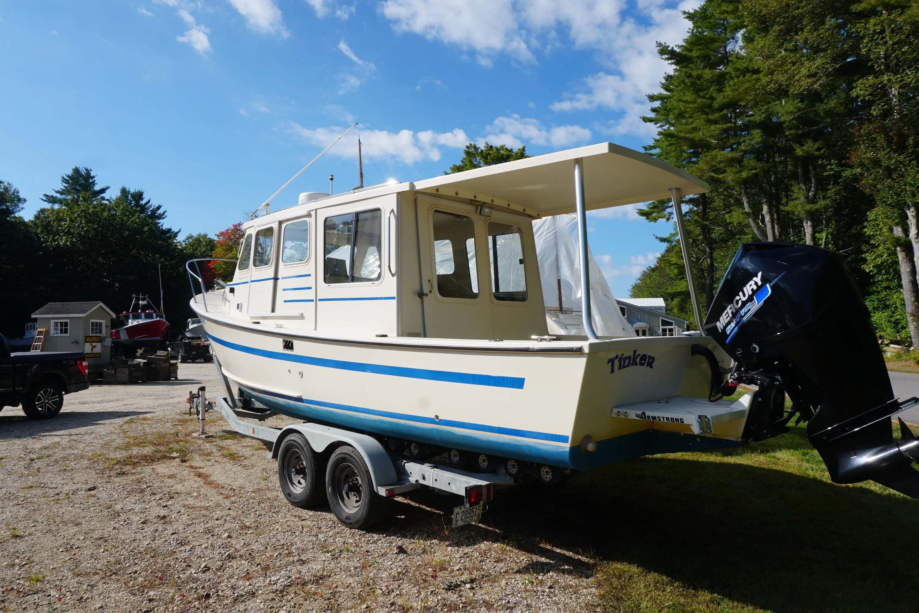 2002 Rosborough RF-246 Sedan Cruiser on trailer, parked outdoors under a clear blue sky.