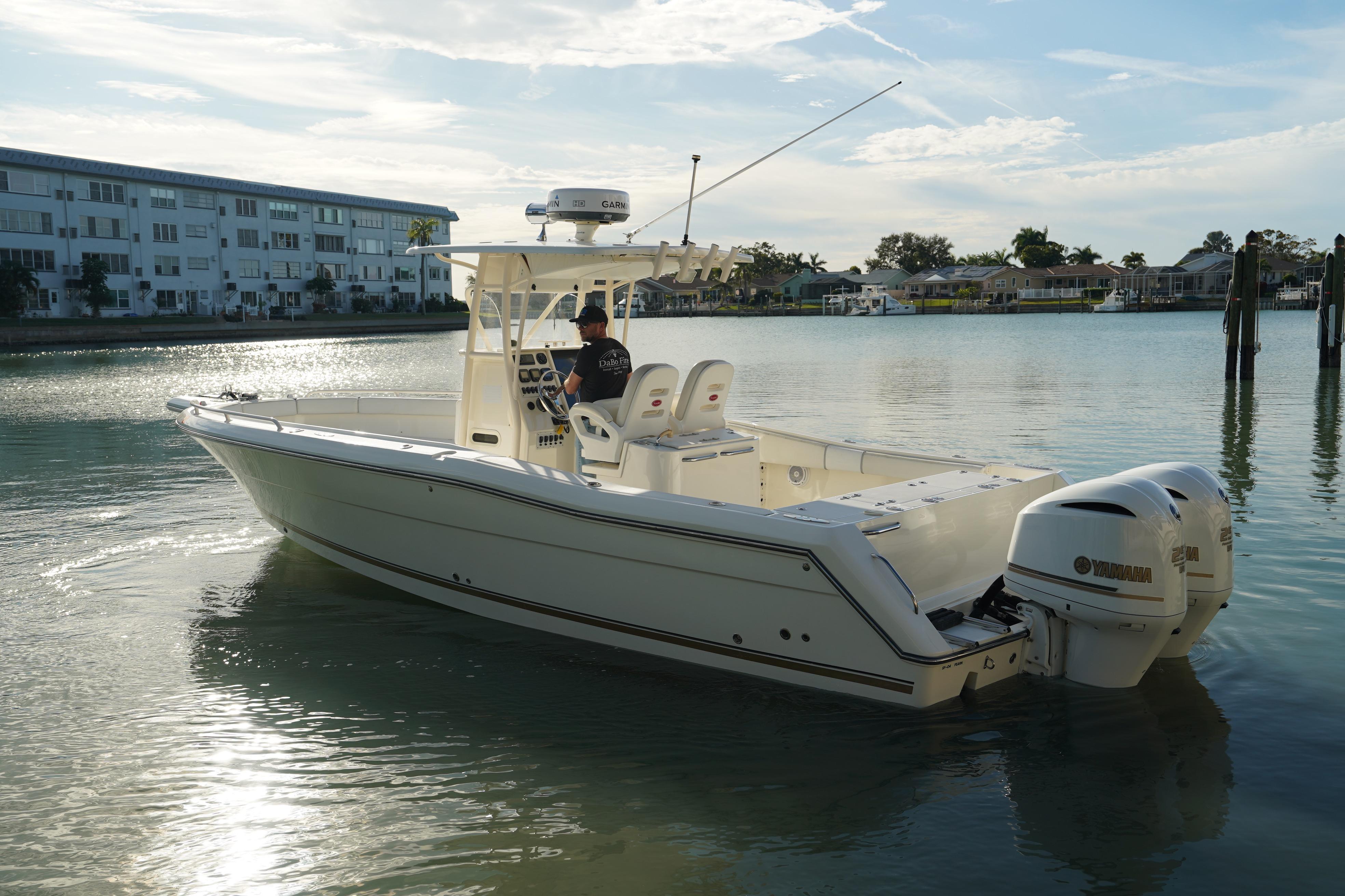 2013 Stamas 317 Tarpon boat with dual Yamaha engines on calm water.