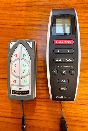 Lone Ranger Yacht Photos Pics Two remote controls on a wooden surface for a 2017 Ranger Tugs Sedan.