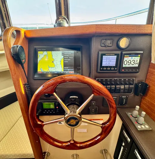 Lone Ranger Yacht Photos Pics 2017 Ranger Tugs Sedan helm with navigation screens and wooden steering wheel.