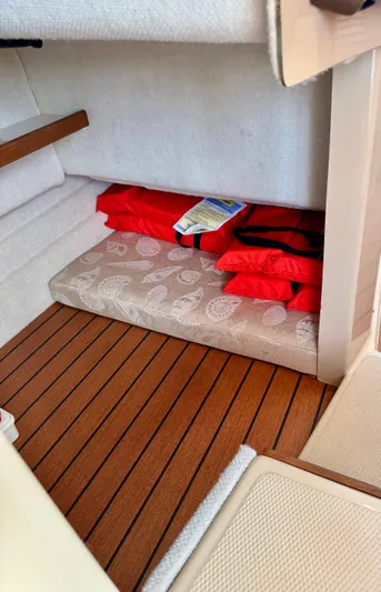 Lone Ranger Yacht Photos Pics 2017 Ranger Tugs Sedan interior with red life jackets on a patterned cushion.