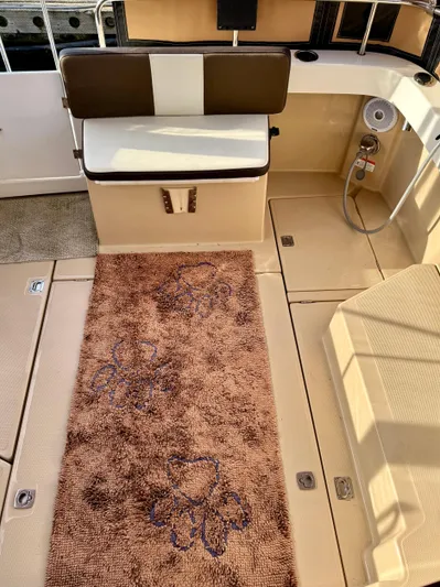 Lone Ranger Yacht Photos Pics 2017 Ranger Tugs Sedan interior with brown rug and cushioned seating.