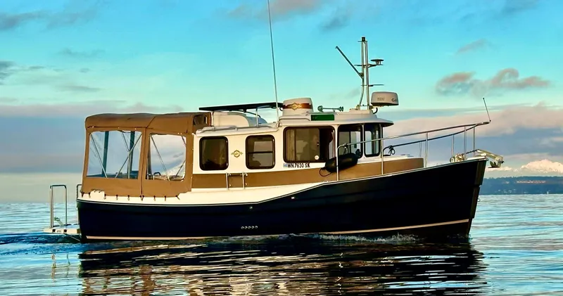 Lone Ranger Yacht Photos Pics 2017 Ranger Tugs Sedan boat cruising on calm water under a clear sky.