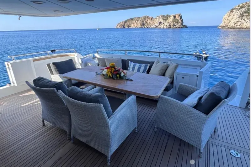 Blue Moon Yacht Photos Pics Luxury Sanlorenzo SL88 yacht deck with elegant seating, ocean view, and island backdrop.