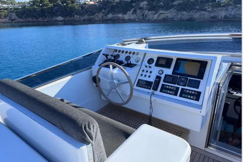 Blue Moon Yacht Photos Pics Cockpit of 2000 Sanlorenzo SL88 yacht with navigation controls, overlooking serene blue waters.