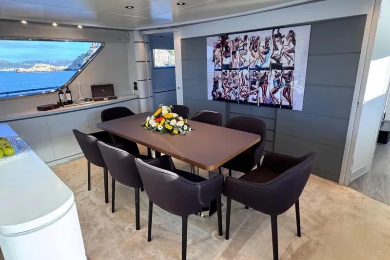 Blue Moon Yacht Photos Pics Luxurious dining area on 2000 Sanlorenzo SL88 yacht with elegant decor and sea view.