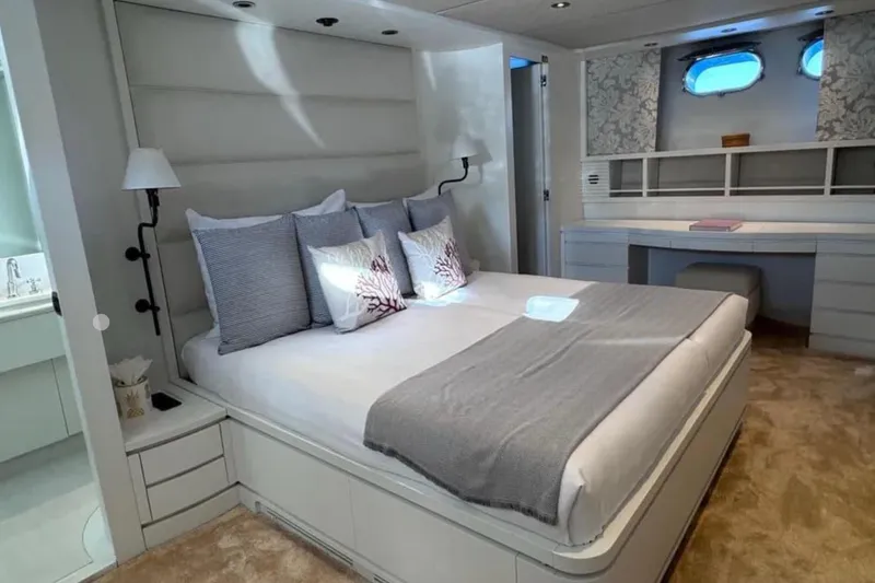 Blue Moon Yacht Photos Pics Luxurious bedroom interior of 2000 Sanlorenzo SL88 yacht with elegant decor and modern furnishings.