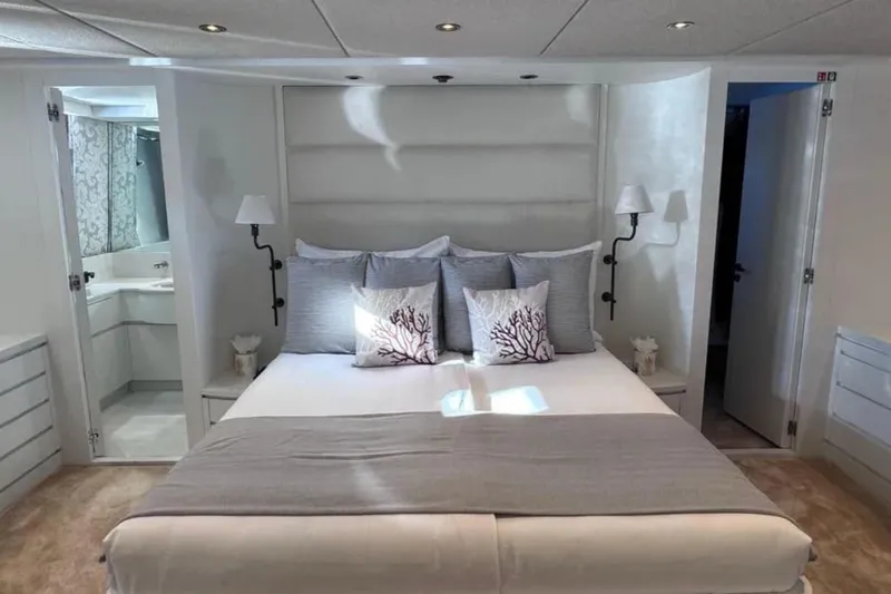 Blue Moon Yacht Photos Pics Luxurious bedroom interior on 2000 Sanlorenzo SL88 yacht, featuring elegant decor and plush bedding.