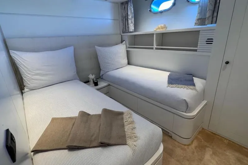 Blue Moon Yacht Photos Pics Twin cabin interior of 2000 Sanlorenzo SL88 yacht with cozy beds and nautical decor.