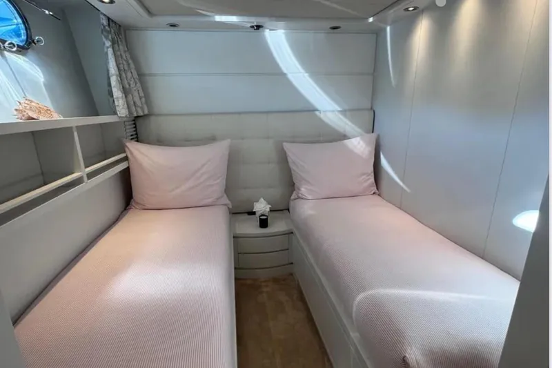 Blue Moon Yacht Photos Pics Twin cabin with pink bedding on a 2000 Sanlorenzo SL88 yacht.