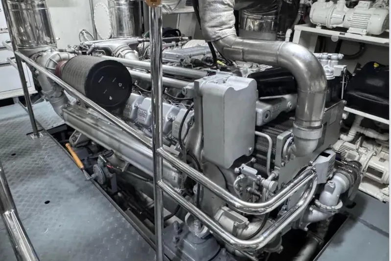 Blue Moon Yacht Photos Pics Engine room of a 2000 Sanlorenzo SL88 yacht, showcasing intricate machinery and piping.