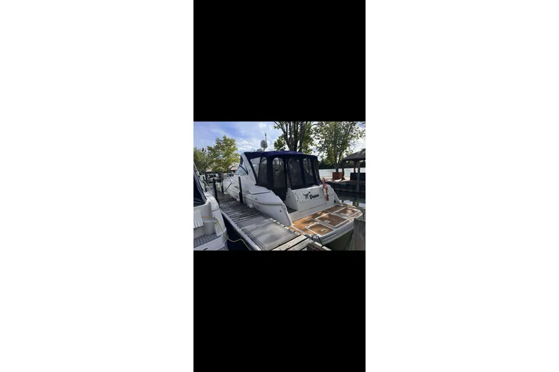  Yacht Photos Pics 2004 Cruisers Yachts 400 Express docked, rear view with trees in background.