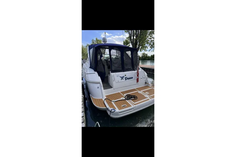  Yacht Photos Pics 2004 Cruisers Yachts 400 Express docked, featuring a spacious rear deck and canopy.