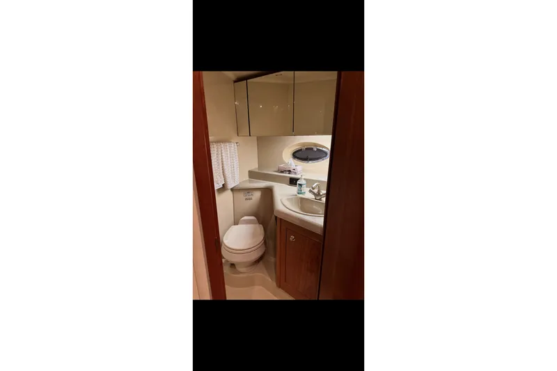  Yacht Photos Pics Bathroom interior of 2004 Cruisers Yachts 400 Express with sink and toilet.