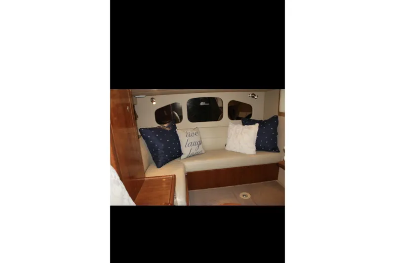  Yacht Photos Pics Interior of 2004 Cruisers Yachts 400 Express with cozy seating and decorative pillows.