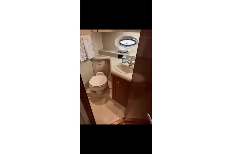  Yacht Photos Pics Bathroom interior of 2004 Cruisers Yachts 400 Express with sink and toilet.