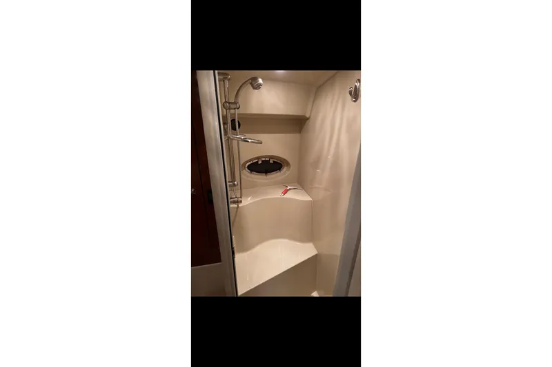  Yacht Photos Pics Shower area in 2004 Cruisers Yachts 400 Express, featuring modern fixtures and porthole window.