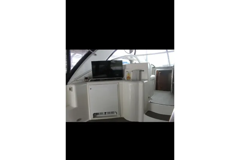  Yacht Photos Pics 2004 Cruisers Yachts 400 Express interior with TV and kitchenette area.