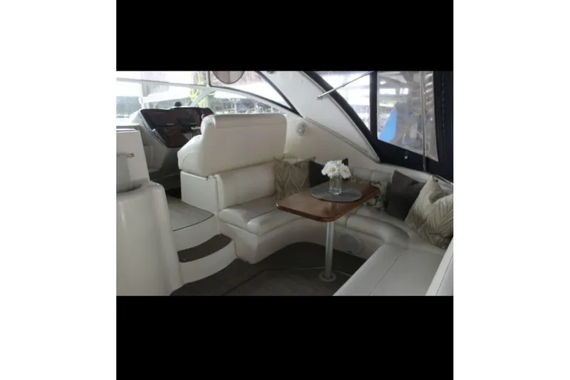  Yacht Photos Pics 2004 Cruisers Yachts 400 Express interior with white seating and wooden table.