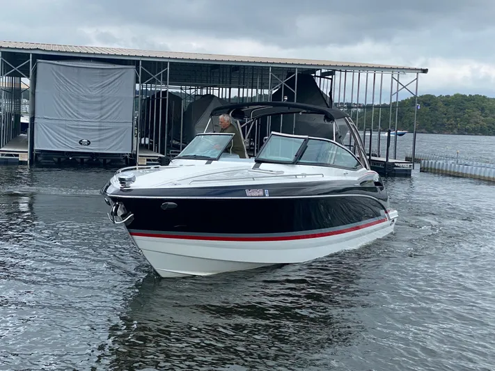  Yacht Photos Pics 2012 Formula 350 SS FX6 boat docked on a lake under cloudy skies.