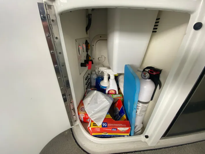  Yacht Photos Pics Storage compartment in 2012 Formula 350 SS FX6 boat with cleaning supplies and fire extinguisher.