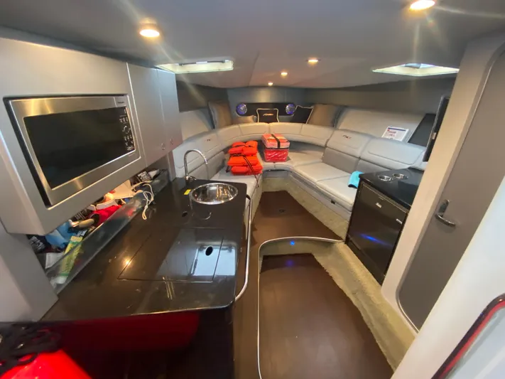  Yacht Photos Pics Interior of 2012 Formula 350 SS FX6 boat with kitchenette and seating area.