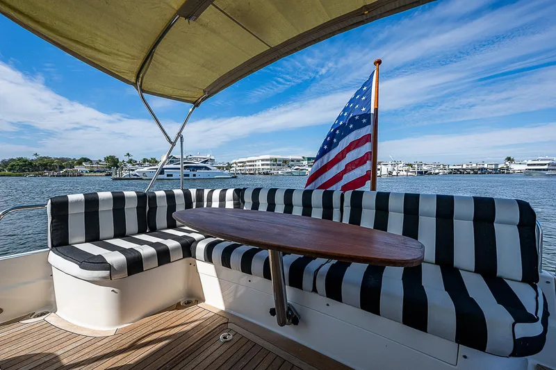 Captain And The Kid Yacht Photos Pics 2012 Sabre 48 Salon Express yacht with striped seating and American flag.