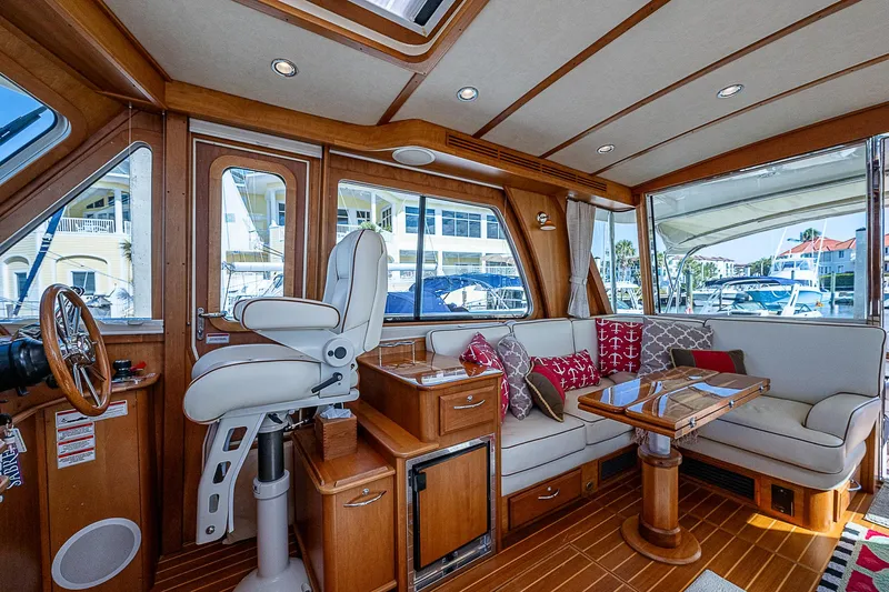 Captain And The Kid Yacht Photos Pics Interior of 2012 Sabre 48 Salon Express yacht with luxurious seating and wooden finishes.