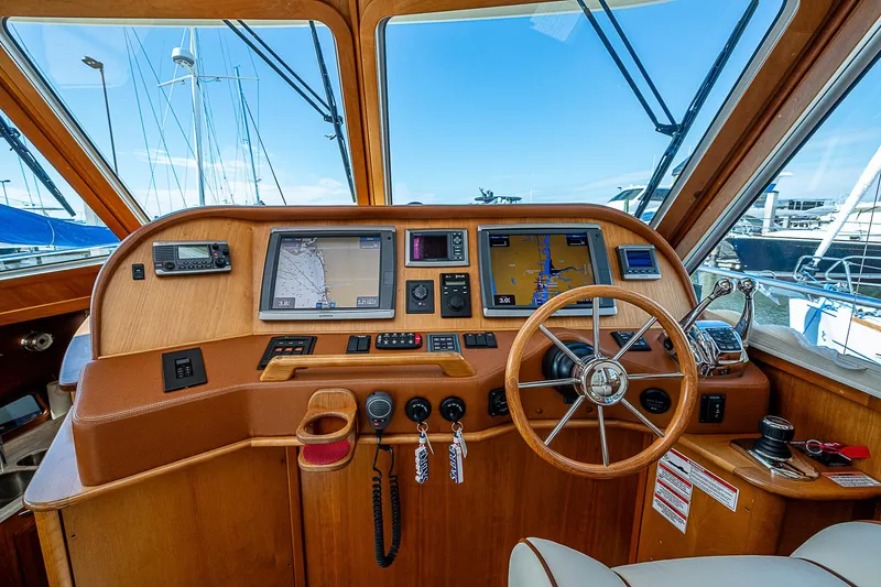 Captain And The Kid Yacht Photos Pics 2012 Sabre 48 Salon Express helm with navigation screens and wooden steering wheel.