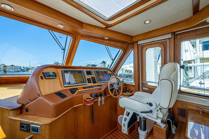 Captain And The Kid Yacht Photos Pics Interior of 2012 Sabre 48 Salon Express yacht, featuring helm and captain's chair.