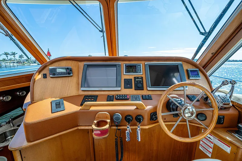 Captain And The Kid Yacht Photos Pics 2012 Sabre 48 Salon Express helm with wooden steering wheel and navigation screens.
