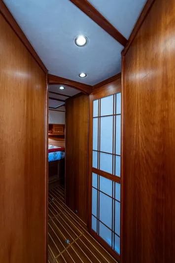 Captain And The Kid Yacht Photos Pics 2012 Sabre 48 Salon Express interior hallway with wooden paneling and recessed lighting.