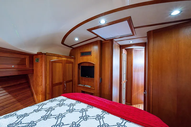 Captain And The Kid Yacht Photos Pics Interior of 2012 Sabre 48 Salon Express yacht, featuring wood paneling and cozy bedroom.