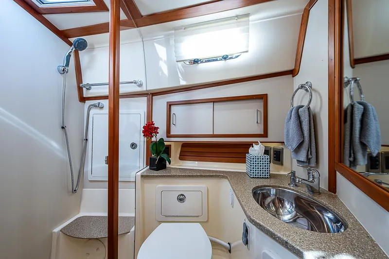 Captain And The Kid Yacht Photos Pics Luxurious bathroom in 2012 Sabre 48 Salon Express yacht with modern fixtures and elegant design.