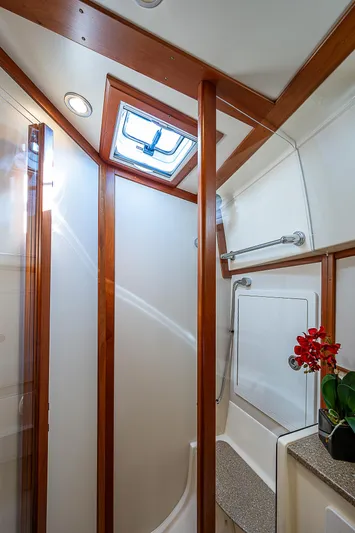 Captain And The Kid Yacht Photos Pics 2012 Sabre 48 Salon Express bathroom with skylight, wood accents, and floral decor.